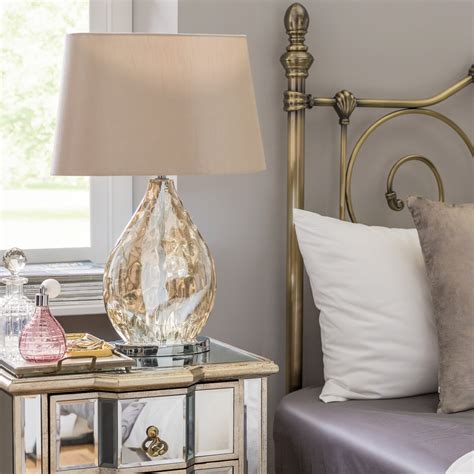 This 2-piece set of accent lamps brings a coordinated, symmetrical look to your end tables or nightstands. Each lamp has an openwork wrought iron base with a ...
